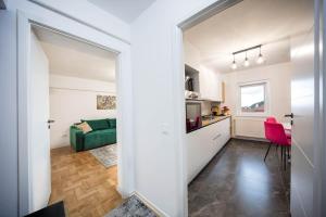 a hallway leading to a kitchen and a living room at City Center Sanctuary in Braşov