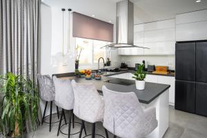 a kitchen with a island with bar stools at Naxos Town House in Naxos Chora