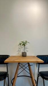 a wooden table with a potted plant on top of it at 山有巷宅 Alley house in Puli