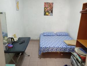 a small bedroom with a bed and a table at Private Studio 17 in Tirana