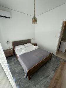 a bedroom with a large bed in a room at Mano’s House Preveza in Preveza +4 photos