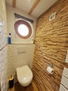 a small bathroom with a toilet and a window at Cabanes du Domaine des Fées in Dole