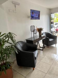 a living room with two chairs and a table at HOTEL PORTO in Valença +24 photos