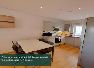 a small kitchen with a table in a room at Cliffe Terrace W 1 Free Parking Space in Chatham