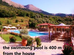 a swimming pool with a mountain in the background at Rustic House in Émbonas