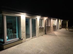 a row of windows on a building at night at House Gowlane in Castlegregory