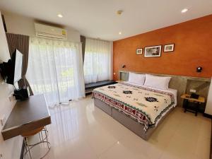 a bedroom with a large bed in a room at Ideo Phuket Hotel - SHA Extra Plus in Nai Yang Beach