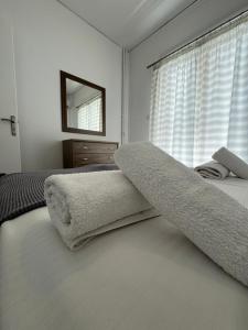 a bedroom with a bed and a mirror and a window at Mano’s House Preveza in Preveza