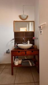 a bathroom with a sink and a mirror at Angel House in Drosia