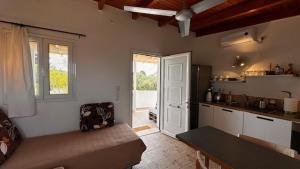 a living room with a couch and a kitchen at Angel House in Drosia