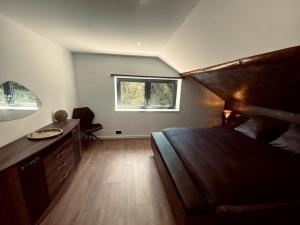 a bedroom with a bed and a desk and a window at Appartement 1000 et une nuits in Saint-Avold