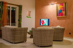 TV a/nebo společenská místnost v ubytování Residence Can' Hibiscus