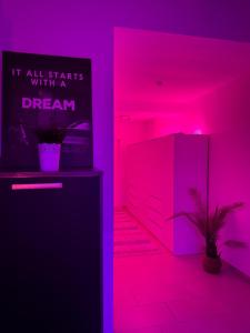 a pink room with a refrigerator and a plant at Designer Loft City Center, Secured parking, cozy Apartment, Adenau Nürburgring in Adenau +17 photos