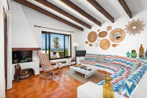a living room with a couch and a fireplace at Bini Luna - Binibeca Vell in Binibeca