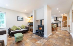 a living room with a couch and a fireplace at The Lawns in Elterwater