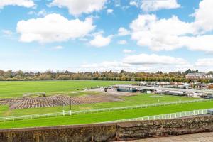 a horse race track with a green field and buildings at The POPULAR Chester Racecourse Apartments, Duplex, Sleeps 4, FREE Parking in Hough Green