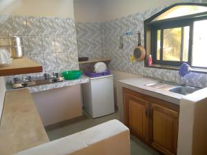 a small kitchen with a sink and a window at RKS - Résidence Kribi Soleil in Kribi +49 photos
