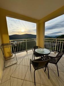 a balcony with a table and chairs and a view at Prijevor Apartments in Budva
