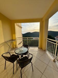 a balcony with a table and chairs and a view at Prijevor Apartments in Budva