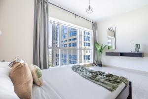 Postel nebo postele na pokoji v ubytování GuestReady - Luxe Studio with JLT Park View