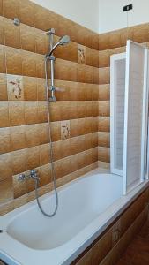 a bathroom with a shower and a bath tub at Appartamento Laura in Quargnento +37 photos