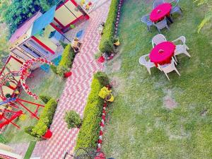 an aerial view of a miniature park with tables and chairs at Bundeli Farm Resort & Banquet Orchha in Orchha