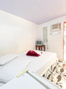 A bed or beds in a room at Pousada Paraíso