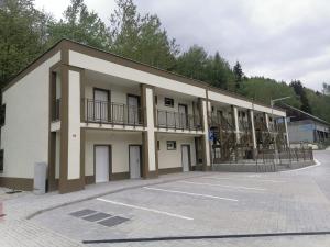 a building with a parking lot in front of it at Apartment Ski and Relax in Horní Žďár