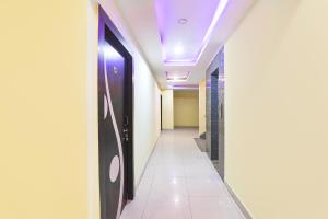 a corridor in a hospital with a purple ceiling at FabHotel Magadh Regency in Patna