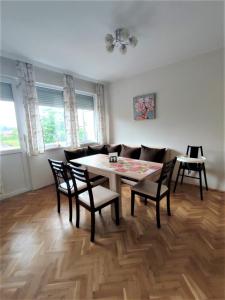 a dining room with a table and chairs at Rozina by RV Apartments in Kazanlŭk