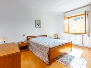 a bedroom with a bed and a desk and a window at Comfy Old Fashion Apartment with Balcony in Gonnesa