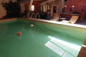 a swimming pool with a ball in the water at Chambres d'Hôtes Le relais des marmottes in Lagnes