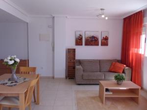 a living room with a couch and a table at Marina d’Or Beachfront-Vista al mar frontal in Oropesa del Mar