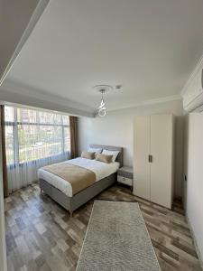 a bedroom with a bed and a large window at Öztürk VIP in Pelitli