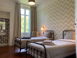 Ένα ή περισσότερα κρεβάτια σε δωμάτιο στο Gîte La Maison du Moulin de Sologne