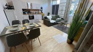 a living room with a table and chairs in a living room at Appartment Rosengarten in Baden