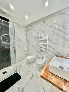 biała łazienka z umywalką i toaletą w obiekcie Oltremare w mieście Bari