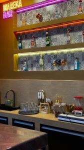 a counter in a restaurant with a bar with glasses at MARENA Poolvilla UdonThani in Udon Thani