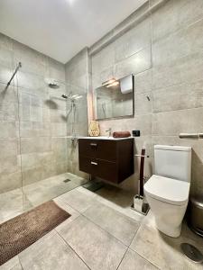 Un baño con inodoro, ducha y lavabo. en Sabino Street Apartment, en Santa Cruz de Tenerife