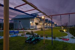 a playground in front of a house at night at Osada Skandia Kopań in Kopań