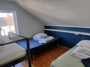 a small room with two beds and a window at FeelHome 4 bedrooms apartment Polarvegen in Tromsø