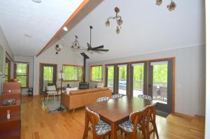 a living room with a table and a couch at Bobcat 22 -- Hot Tub, Game Room, Wifi, Fire Pit, Pool Access, Fireplace, Grill, Screen Porch, Hiking, Deck, King Bed, Pet Friendly in Berkeley Springs