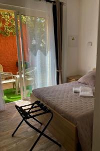 ヴィアにあるHôtel Le Gambettaのベッドルーム1室(ベッド1台付)、スライド式ガラスドアが備わります。