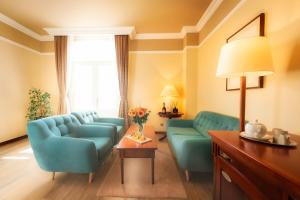 a living room with two blue chairs and a table at BRISTOL Hotel Opatija in Opatija
