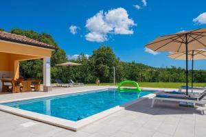 a swimming pool with an umbrella and a table and chairs at Villa Ana Lucija in Labin +14 photos