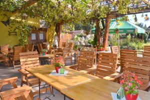 a wooden table and chairs in a patio at Hotel u Jindry in Železnice
