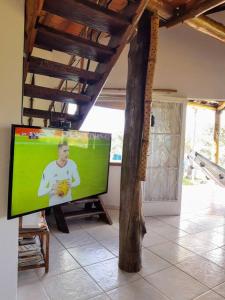 a flat screen tv sitting in a living room at Sítio em Sabará-Ravena com Piscina e internet rápida in Sabará