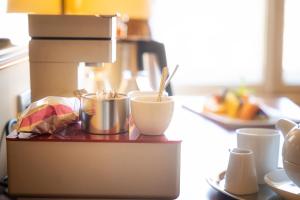 a counter with bowls and cups on top of it at BRISTOL Hotel Opatija in Opatija