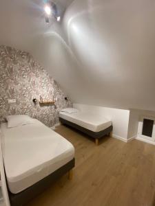 En eller flere senge i et værelse på Maison Stella