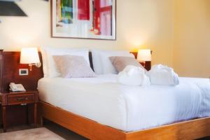 a bedroom with a bed with white sheets and pillows at BRISTOL Hotel Opatija in Opatija
